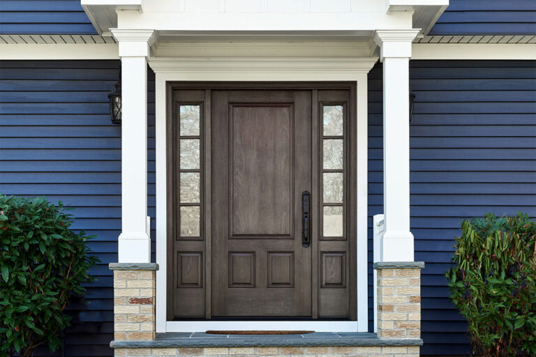 Front door of home with rich blue Market Square siding installed by Dyer Remodeling.